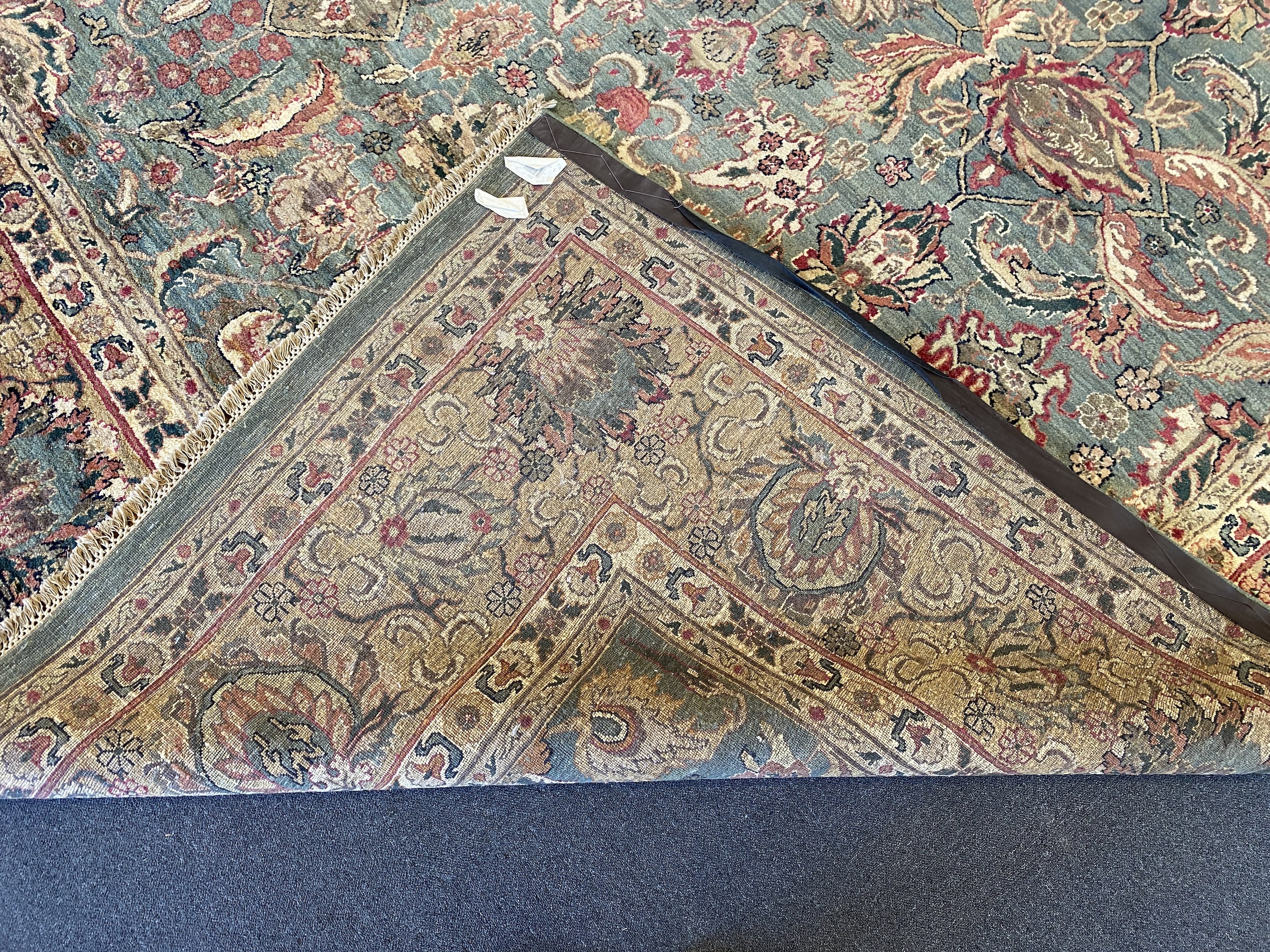 An Indian Persian style sage green ground carpet, 465 x 363cm